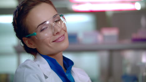 Chemist-woman-smiling.-Close-up-of-female-chemist-face-in-safety-glasses